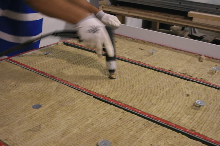 Securing insulation inside a backpan panel